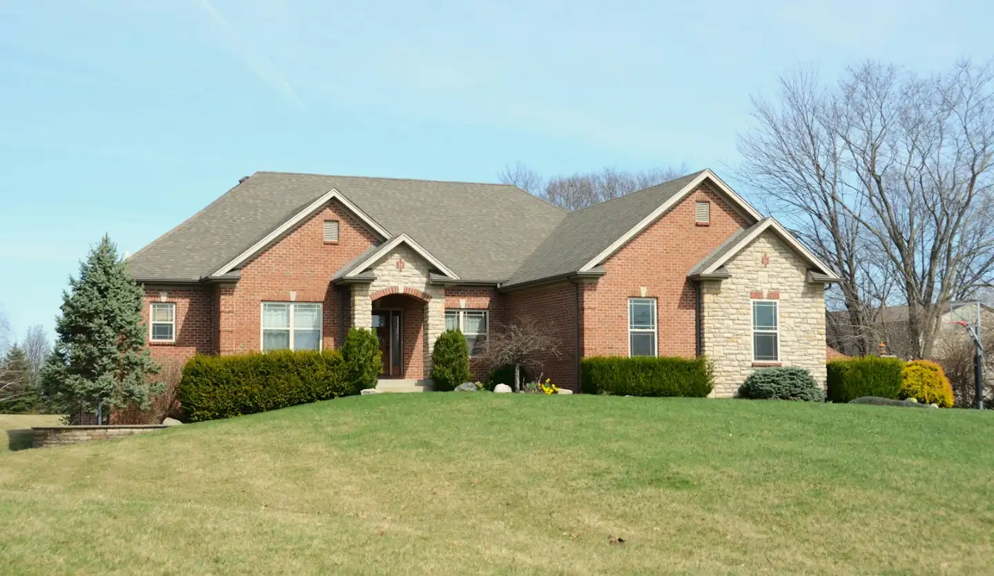 Brick home with front yard wall and lawn in Greenville NC