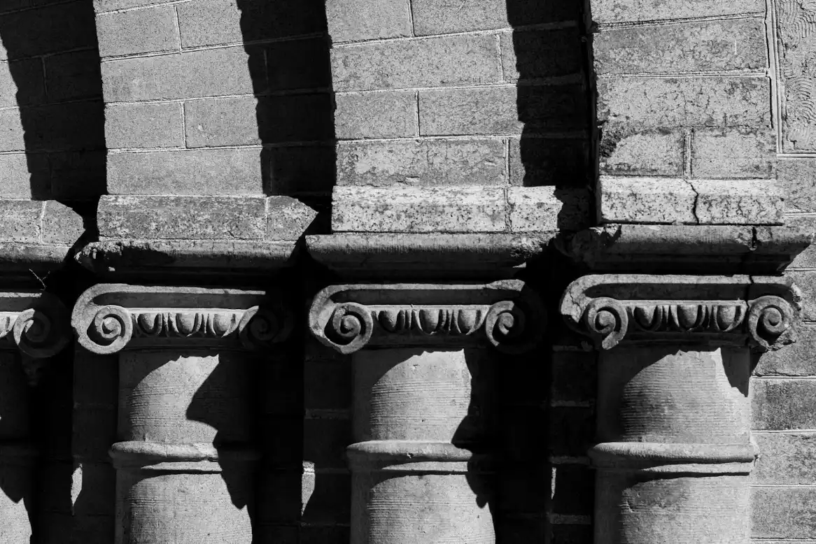 A black and white photo of a row of stone pillars, brick mailbox in Greenville NC