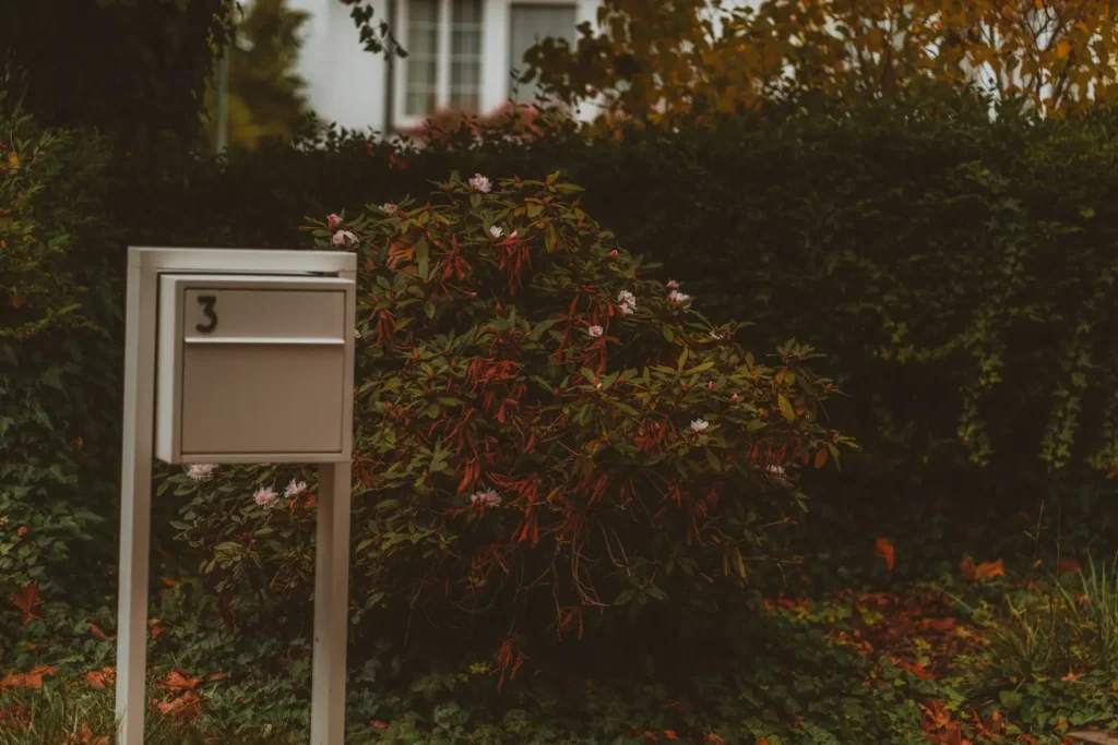 A modern mailbox stands in front of lush greenery, brick mailbox in Greenville NC