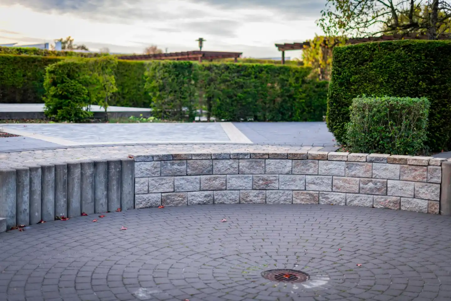Capped low wall around a backyard patio keeping water off the top