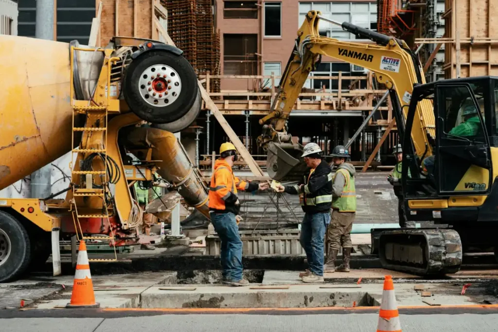 A couple of men standing next to a construction site, concrete cutting in Greenville NC