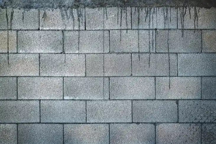 Grey brick wall during daytime, concrete footing in Greenville NC