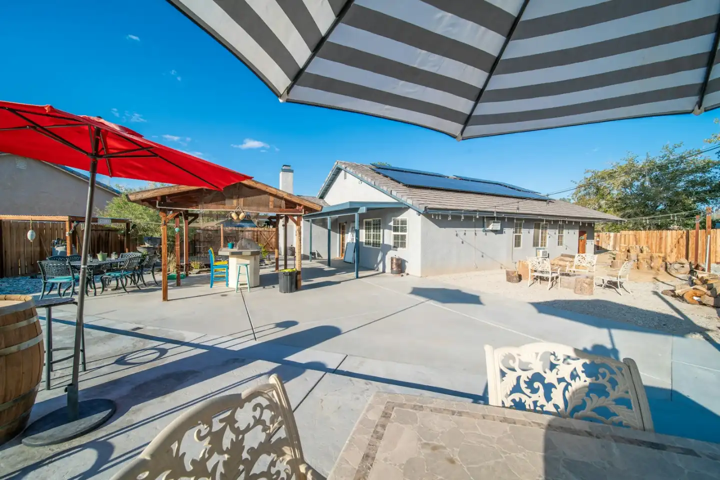 A patio with a table, chairs, and umbrellas, concrete patio in Greenville NC