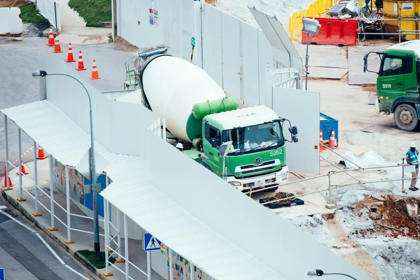 Green and white mixer truck at the construction site, concrete slab in Greenville NC