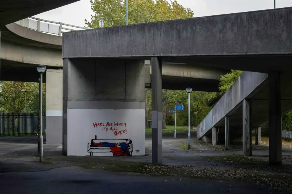 Red and black motorcycle parked near white concrete building during daytime, concrete slab