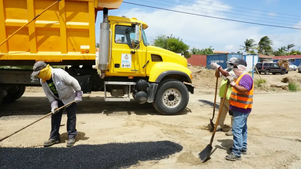 Workers paving a road next to a dump truck, concrete slab in Greenville NC