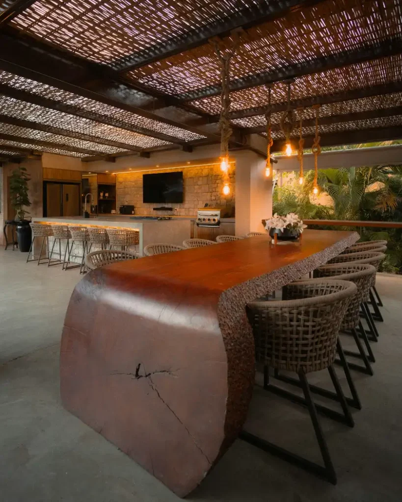 Large wooden table with chairs in outdoor dining area, outdoor kitchen in Greenville NC