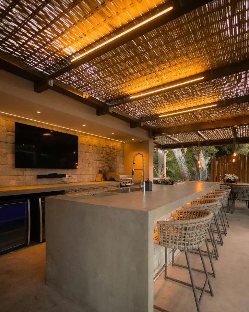 Modern outdoor kitchen with bar and seating in Greenville NC