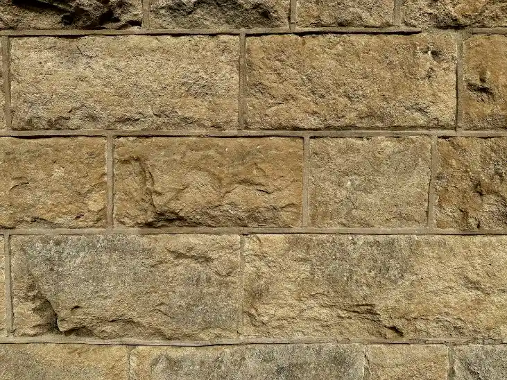 A close up of a wall made of stone blocks, stone masonry in Greenville NC