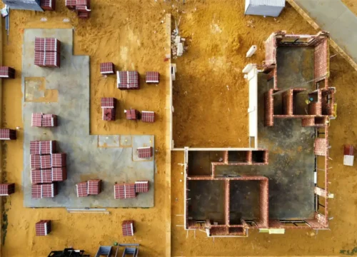 An aerial view of a construction site with tables and chairs, block foundation in Greenville NC