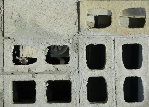 Black rectangular plastic on white concrete, block foundation in Greenville NC