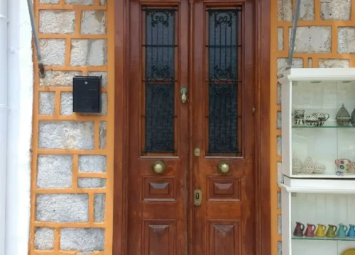 A wooden door sitting next to a brick building, block foundation in Greenville NC
