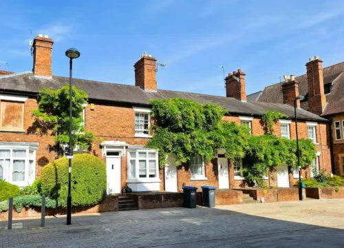 Brick homes with low boundary walls along the front sidewalk