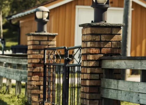 Brick entry pillars and gate at a home driveway