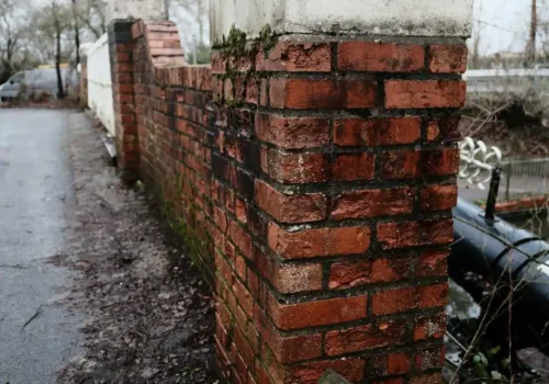 Old weathered brick wall with concrete cap, brick mailbox in Chocowinity NC