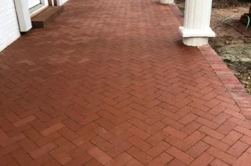 Red brick paver porch with white columns