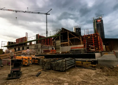 A construction site with a crane in the background, concrete cutting in Greenville NC
