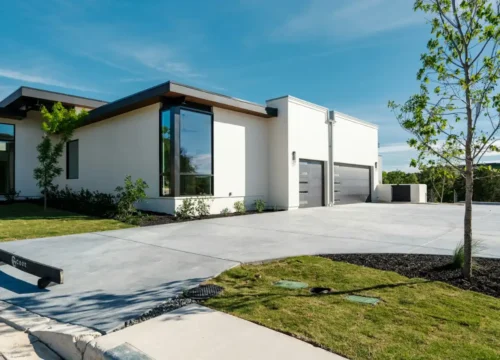Modern white house with large windows and a concrete driveway in Chocowinity NC