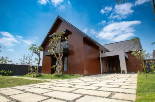 Modern wooden house with stone driveway and green lawn, concrete driveway in Greenville NC