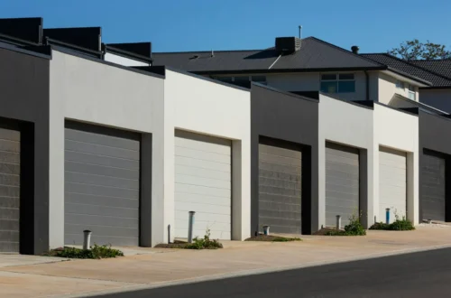 Row of modern garages with dark gray and white doors, concrete driveway in Chocowinity NC