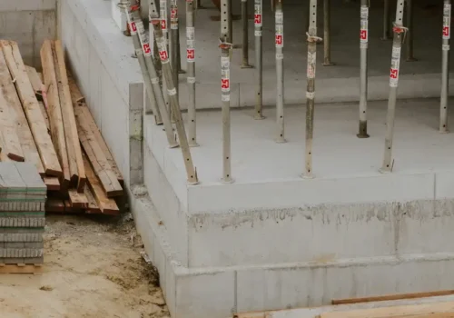 A building under construction with lots of wooden beams, concrete footing in Greenville NC
