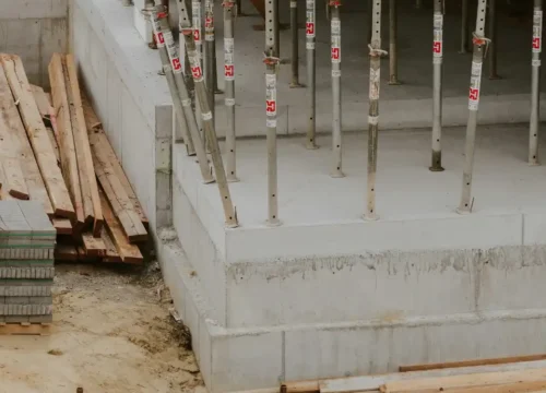 A building under construction with lots of wooden beams, concrete footing in Greenville NC