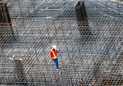 Construction worker inspects rebar on a building site, concrete footing in Belhaven NC