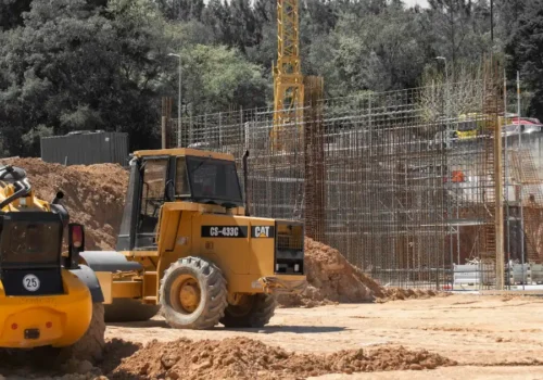 Heavy machinery and scaffolding at a construction site, concrete footing in Greenville NC