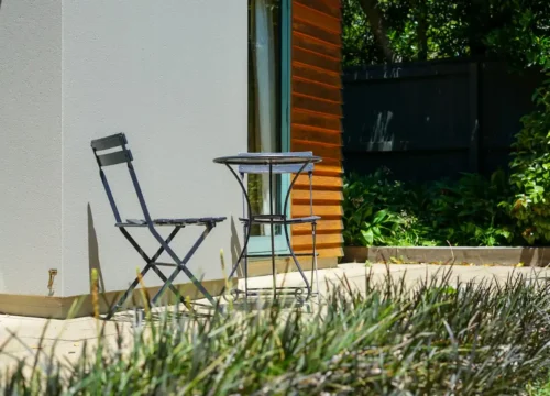 A couple of chairs sitting next to a table, concrete patio in Greenville NC