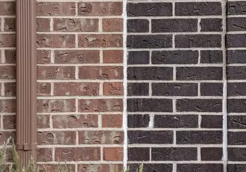 Green grass beside brown brick wall, masonry repair in Greenville NC