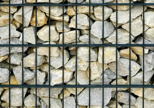 Gabion wall filled with light-colored rocks, retaining wall in Greenville NC